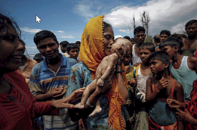 Hamida, a Rohingya refugee woman, weeps as she holds her 40-day-old son after he died as their boat capsized before arriving on shore in Shah Porir Dwip, Teknaf, Bangladesh (Part of Reuters series that won Pulitzer for feature photography).